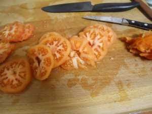 Cortar el tomate en rodajas.