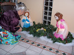 Ms. Irene kneeling at the Manger on Christmas Day