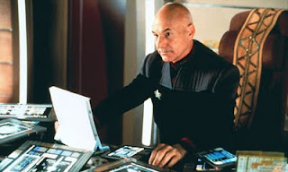 Jean-Luc Picard surrounded by Kindles, Nooks, and Sony EReaders