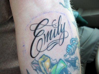 Baby name tattooed on arm.