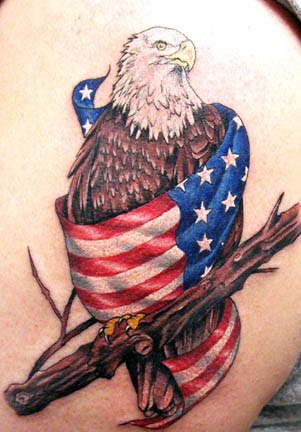 Eagle wrapped in American flag tattoo.
