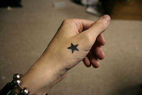 Single star hand tattoo