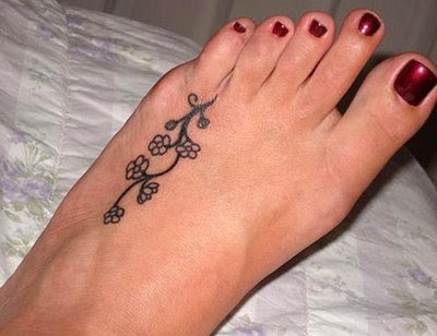 Flower and butterfly tattoos and flower designs on foot