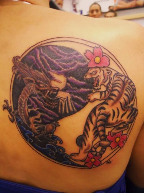Tribal yin yang tattoo design on back left shoulder.