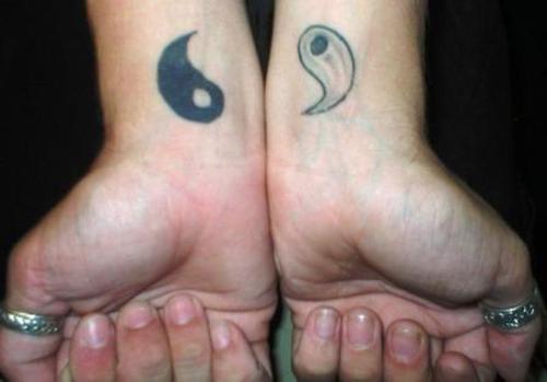 Yin yang tattoo design, one on each wrist.