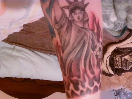 Statue of liberty forearm tattoo idea.