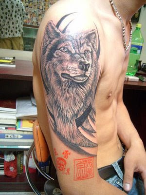 On upper arm with tribal ink.