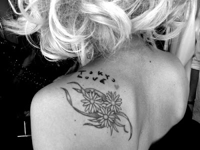 lady gagas tattoos. Lady Gaga has three lily flowers, along with some mysterious scribblings that read quot;Tokyo Lovequot;,