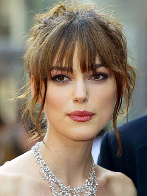 This partial updo with long bangs and a touch of loose and stringy, 