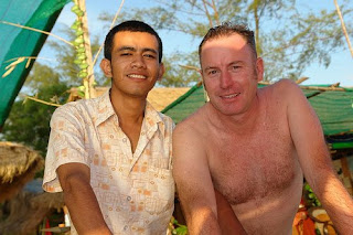 hunk at beach bar with employee