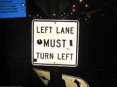 sign that says left lane must turn left