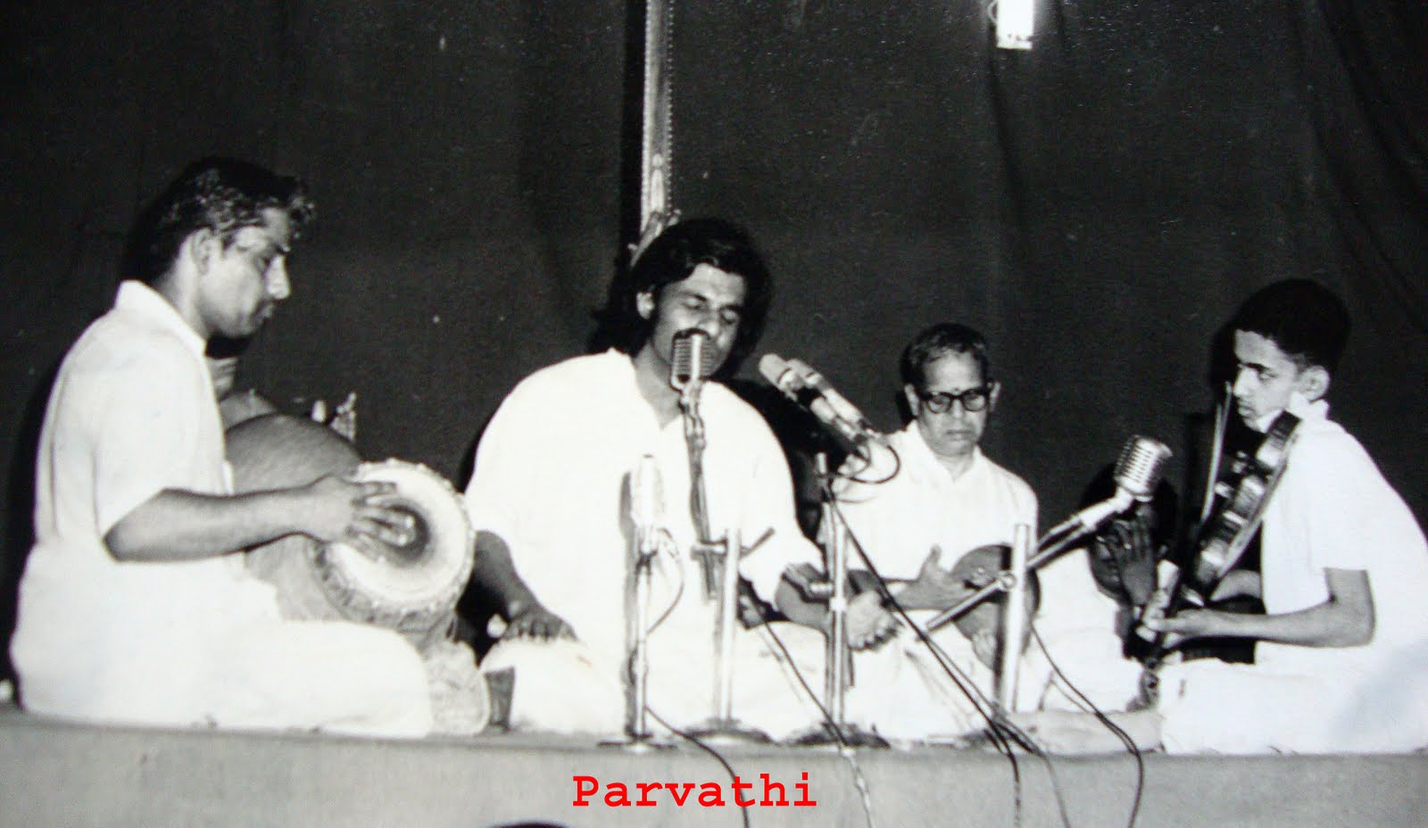 http://4.bp.blogspot.com/_d07xiVjcskE/TJ889OLGZYI/AAAAAAAAAX0/u2udEUklrIM/s1600/watermarked%2BK.J.%2BYesudas,%2BM.%2BNagaraj%2B(Violin),Erode%2BGururajan%2B(Mridangam),S.Das%2B(Kanjira),Manjunath%2B(Ghatam),Parvathi%2BConcert%2B1976.jpg
