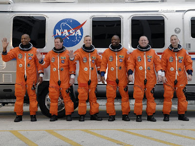 The STS-129 crew members line up beside the Astrovan The STS-129 crew members line up beside the Astrovan