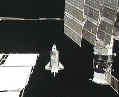 Space shuttle Atlantis flies around the International Space Station Space shuttle Atlantis flies around the International Space Station