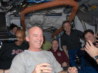 STS-129 and Expedition 21 crew members greet one another after docking on Flight Day 3 STS-129 and Expedition 21 crew members greet one another after docking on Flight Day 3