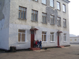 Standing by one of the many orphanage bldgs.