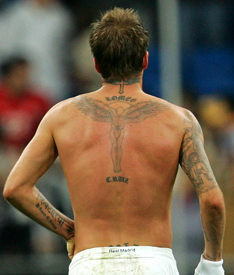 the finishing touches on his full-back tattoo, which lists the names of