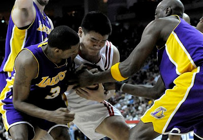 Los Angeles Lakers vs. Houston Rockets on January 13, 2009 in Houston, Texas - Rockets Center Yao Ming Battles For The Ball With Los Angeles Lakers Forwards Trevor Ariza and Lamar Odom