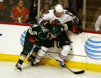 Andrew Brunette and a Chicago Blackhawk player tangled up