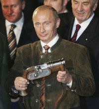 At the time Russian President, Vladimir Putin, wearing a typical Bavarian suit, holds a boeller gun in his hand on October 11, 2006 in Aying near Munich, Germany.