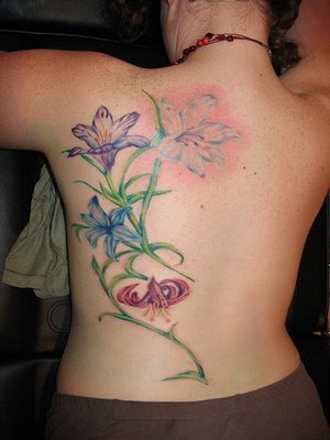 giving tree tattoo. flower back tattoos. flower