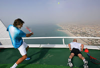 Roger Federer serves on the Burj Al Arab helipad