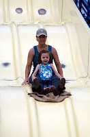 Amy Takes Sophia Down the Slide at the Fair