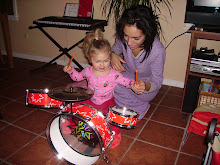 Mami teaching Libby to play the drums on Christmas morning
