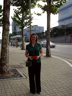 Amber smiles outside on the sidewalk in front of the hotel