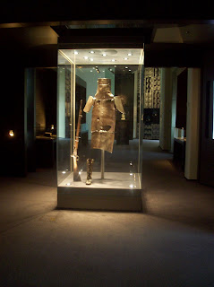 Ned Kelly's armor in a glass case lit by spotlights