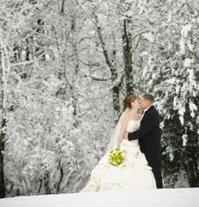 A gorgeous winter wedding couple photograph outside in the forest.
