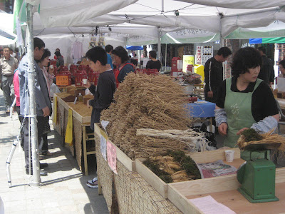 People busy at work maybe selling ginseng