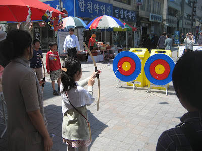 Kids playing with a bow and arrow - again no herbs here