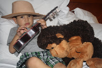 Mateo playing the guitar for his monkey!  He was wearing Aunt Mel's new hat!!