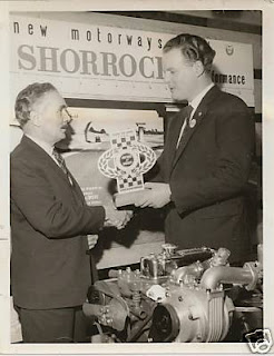 IAN SMITH PRESENTING CHRIS SHORROCK WITH A MERIT AWARD FOR THE SHORROCK STAND, RACING CAR SHOW 1962