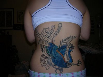 This is a tattoo with the image of the phoenix bird tattoo on the back of This is a tattoo with the image of the phoenix bird tattoo on the back of