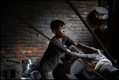 Child Polishing Utensils In A Factory