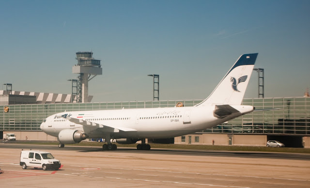 a white airplane on a runway