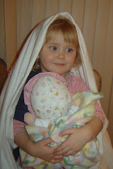 Bailey at Christmas being Mary and holding baby Jesus
