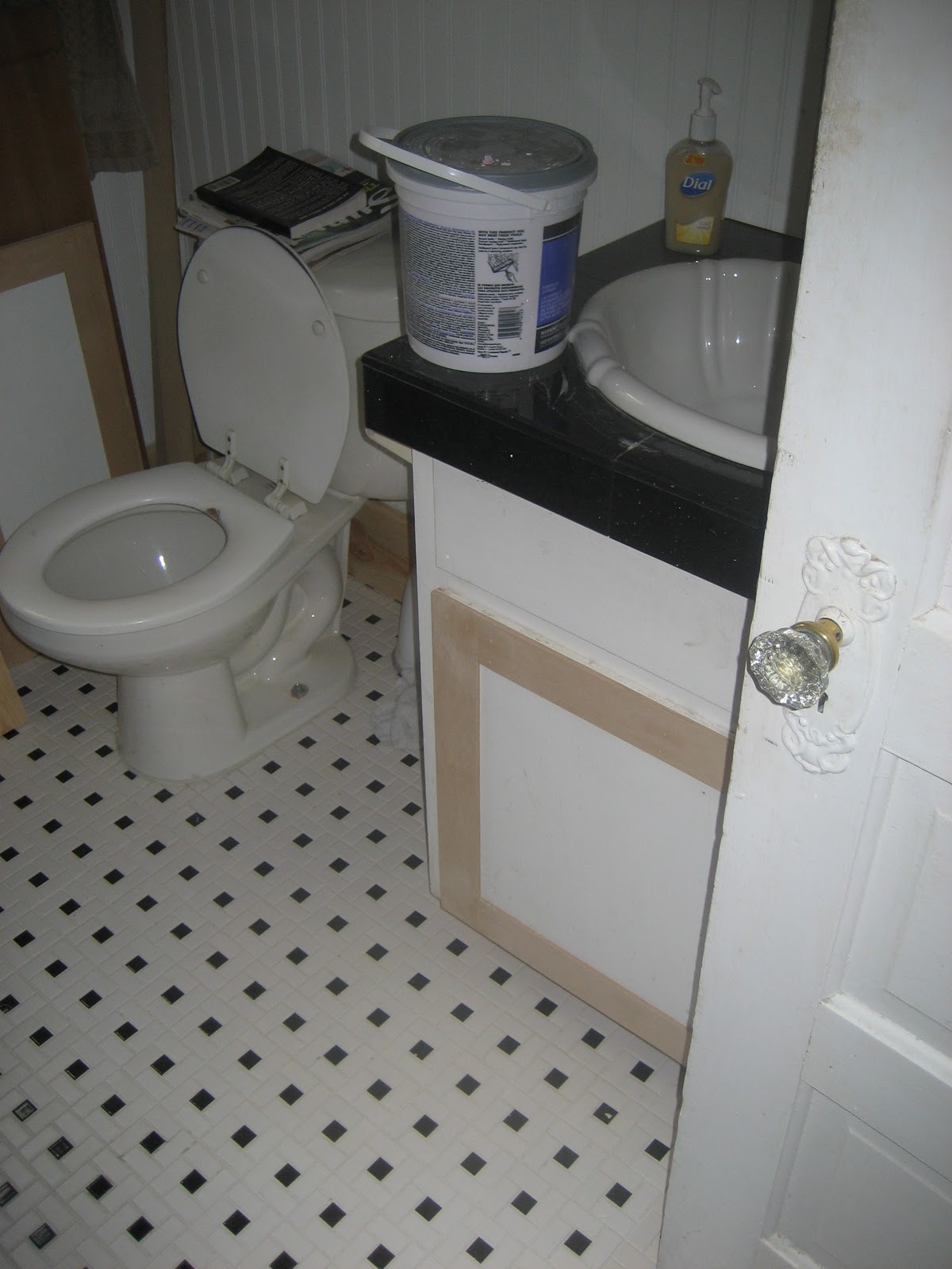 Tile bathroom floor We trimmed out the vanity doors, so they would fit the