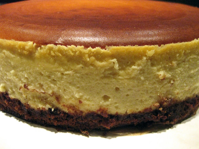 gingersnap crust cheesecake with eggnog cheesecake batter, nutmeg and pomegranate cheesecake glaze