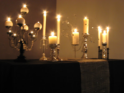 the altar table with silver and black wroughtiron candle sticks 