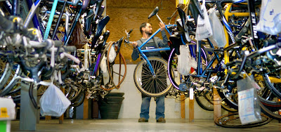 Wess Klunk of Adventure Cycling & Fitness in West Manchester Township pulls down one of the bikes he'll tune up for spring riding.