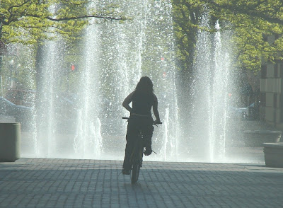 Image of bicyclist near water fountain in downtown Boise