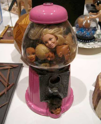 Pink gumball machine full of Barbie and Ken doll heads