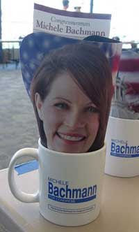 Photo of Michele Bachmann's head dye cut and sticking out of a mug labeled with her name