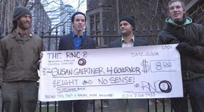 Four members of the RNC 8 holding a large prop check made out to Susan Gaertner for Governor for Eight Dollars and No Sense