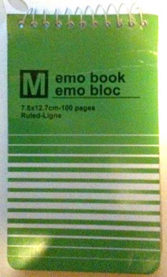 Green notepad cover that says emo book emo bloc with a white M in a black square over to the left of the words