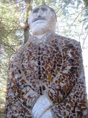 Looming statue covered with brown glass