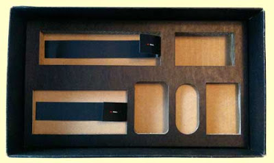 Black tray made out of layers of corrugated cardboard, each component's nest of different depth and shape